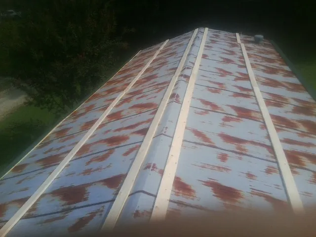 Rusted metal roof panels with new wood purlins before replacement — Storm Damage Roof Repair in Oak Run by Roofing Brothers